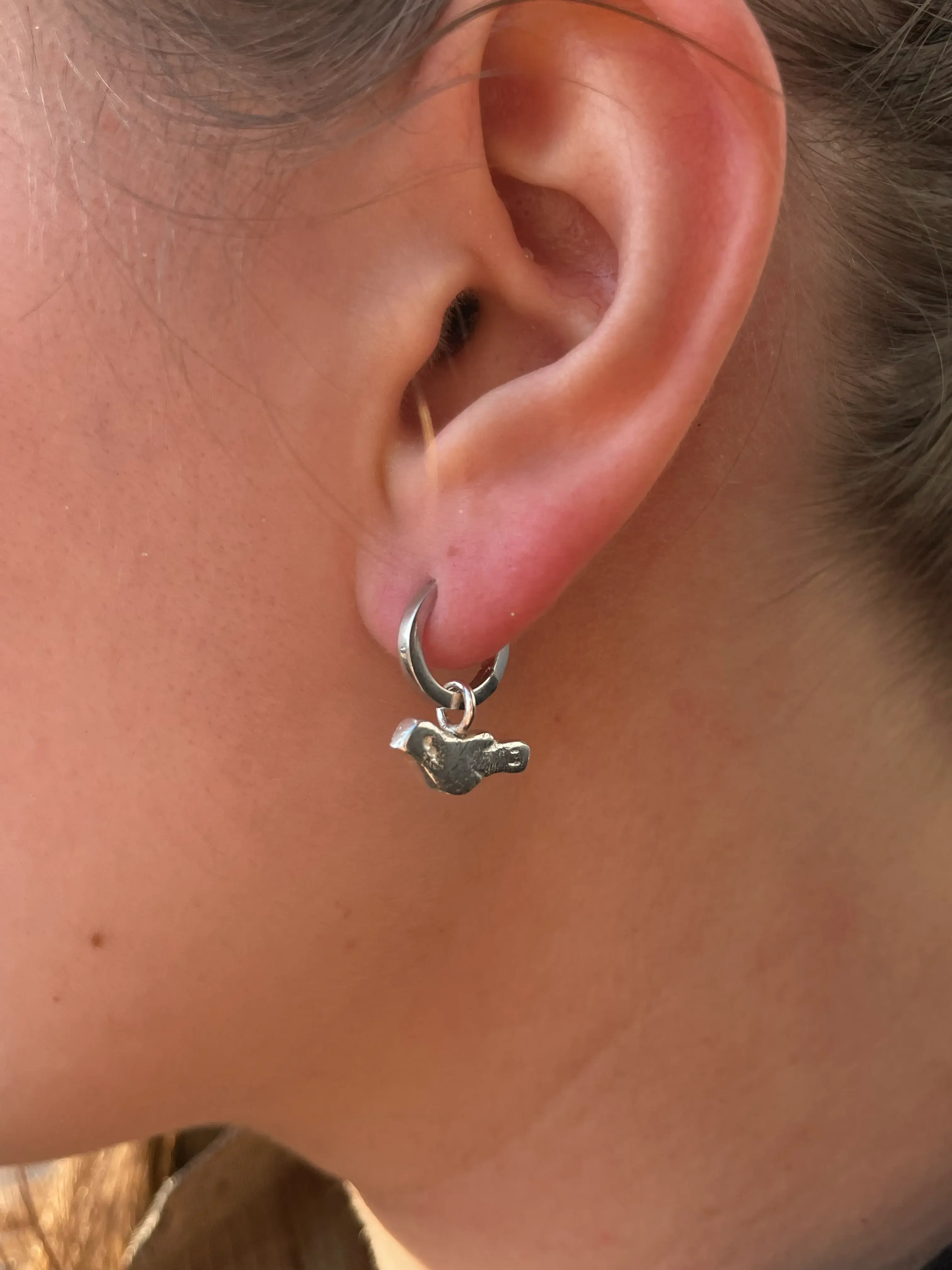 Bird charm worn on ear