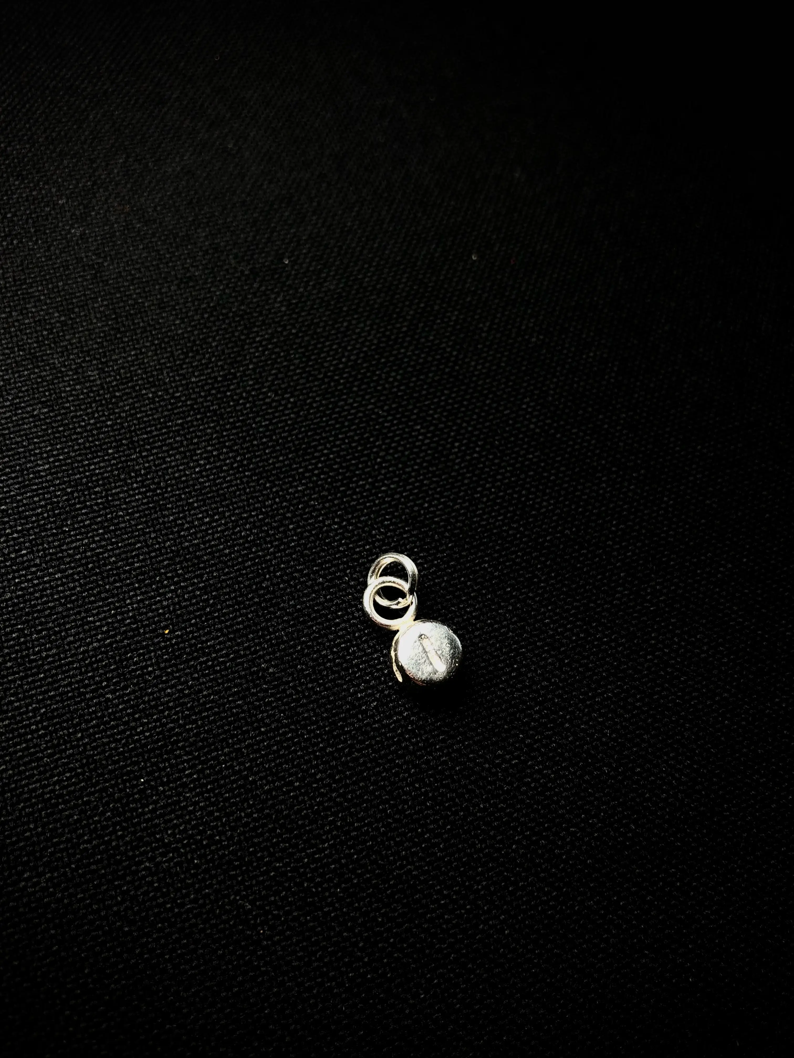 Single silver spring ring attached to a small object